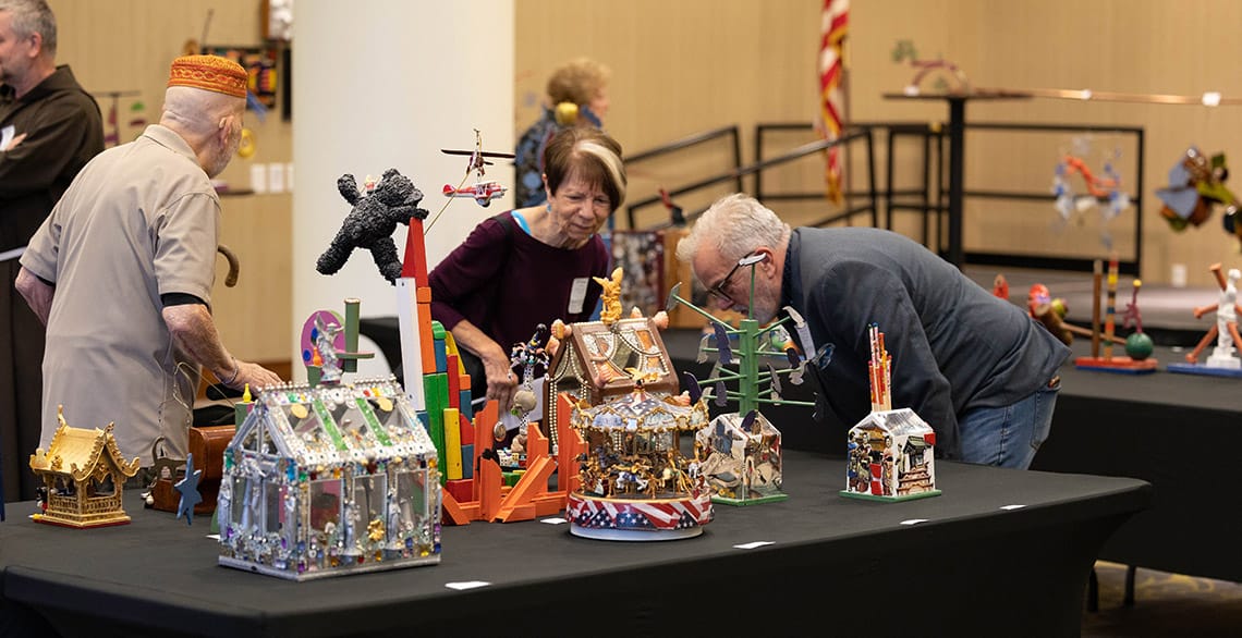 Art benefit attendees look at the various pieces created by "Art from the Heart" organizer Tony Busalacchi. 