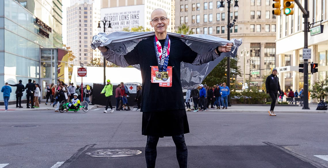 Friar John Celichowski cools down in downtown Detroit after finishing the International Half Marathon.