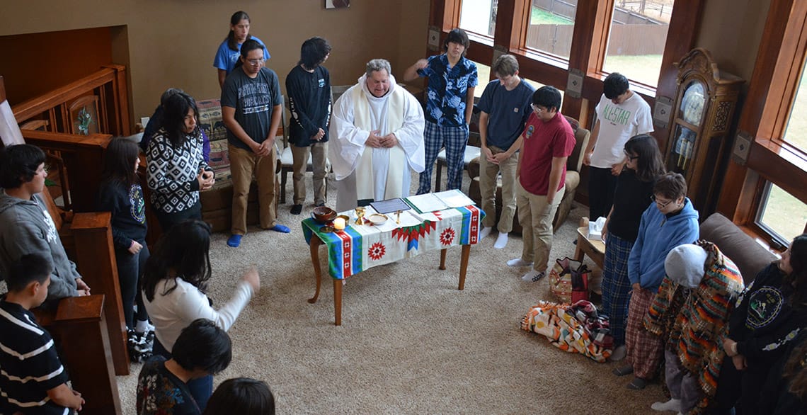 Br. Randy Knauf, OFM Cap. celebrates Mass with a group of students from St. Labre Indian School.