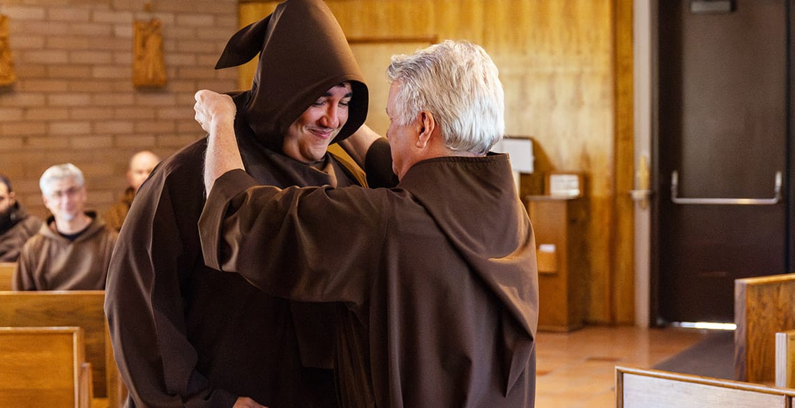 Scott Cotto, OFM Cap. is invested in the Capuchin habit by Provincial Minister Friar Mark Joseph Costello, OFM Cap.